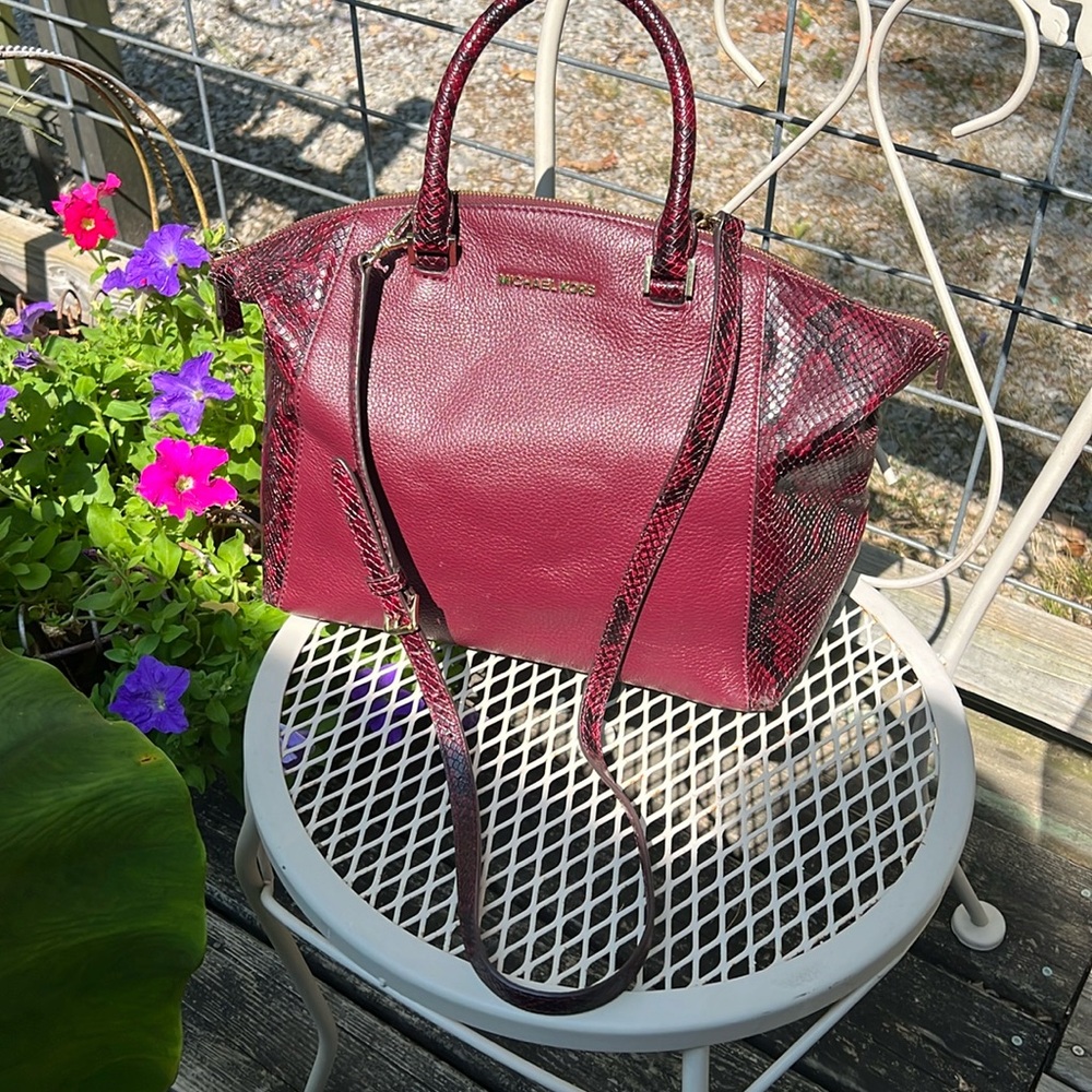 Michael Kors burgundy/black/gold bag with detachable shoulder strap.